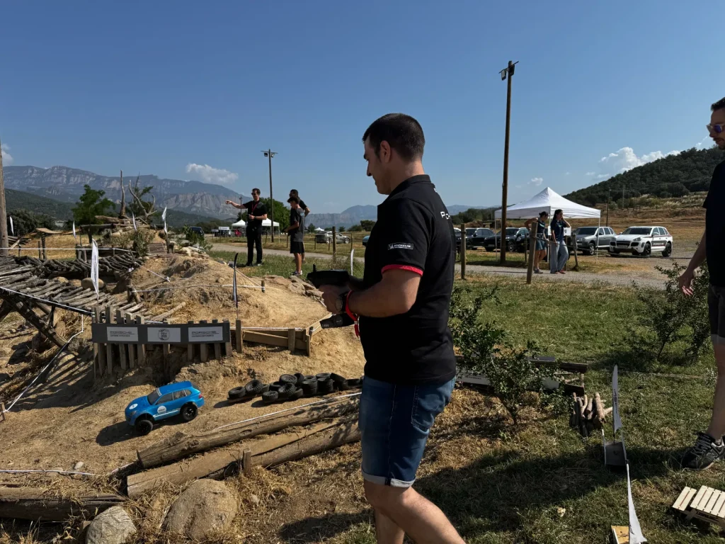 Participante pilotando un crawler RC en el circuito de tierra y troncos en Bassella